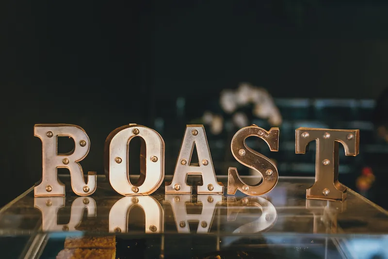 Illuminated ROAST letters on a glass shelf