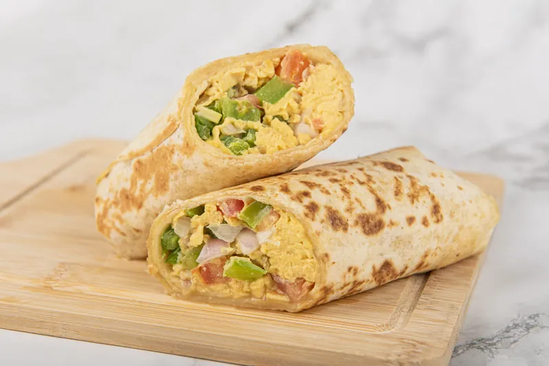 Breakfast Wrap, cut in half to show the egg, pepper and onion filling