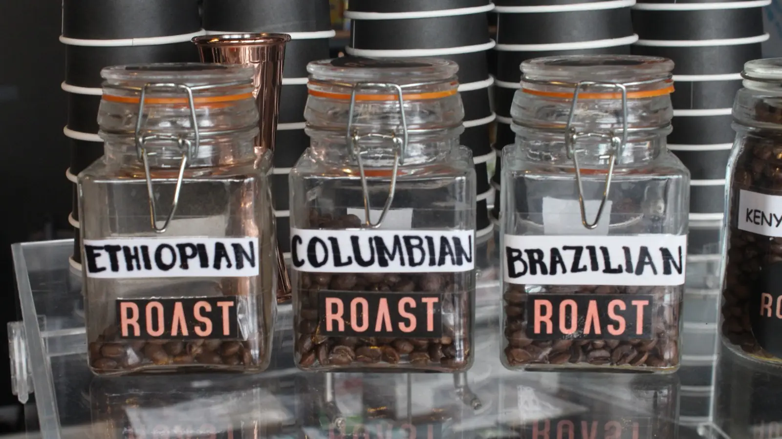 Single-origin beans — Ethiopian, Colombian, Brazilian — in ROAST jars