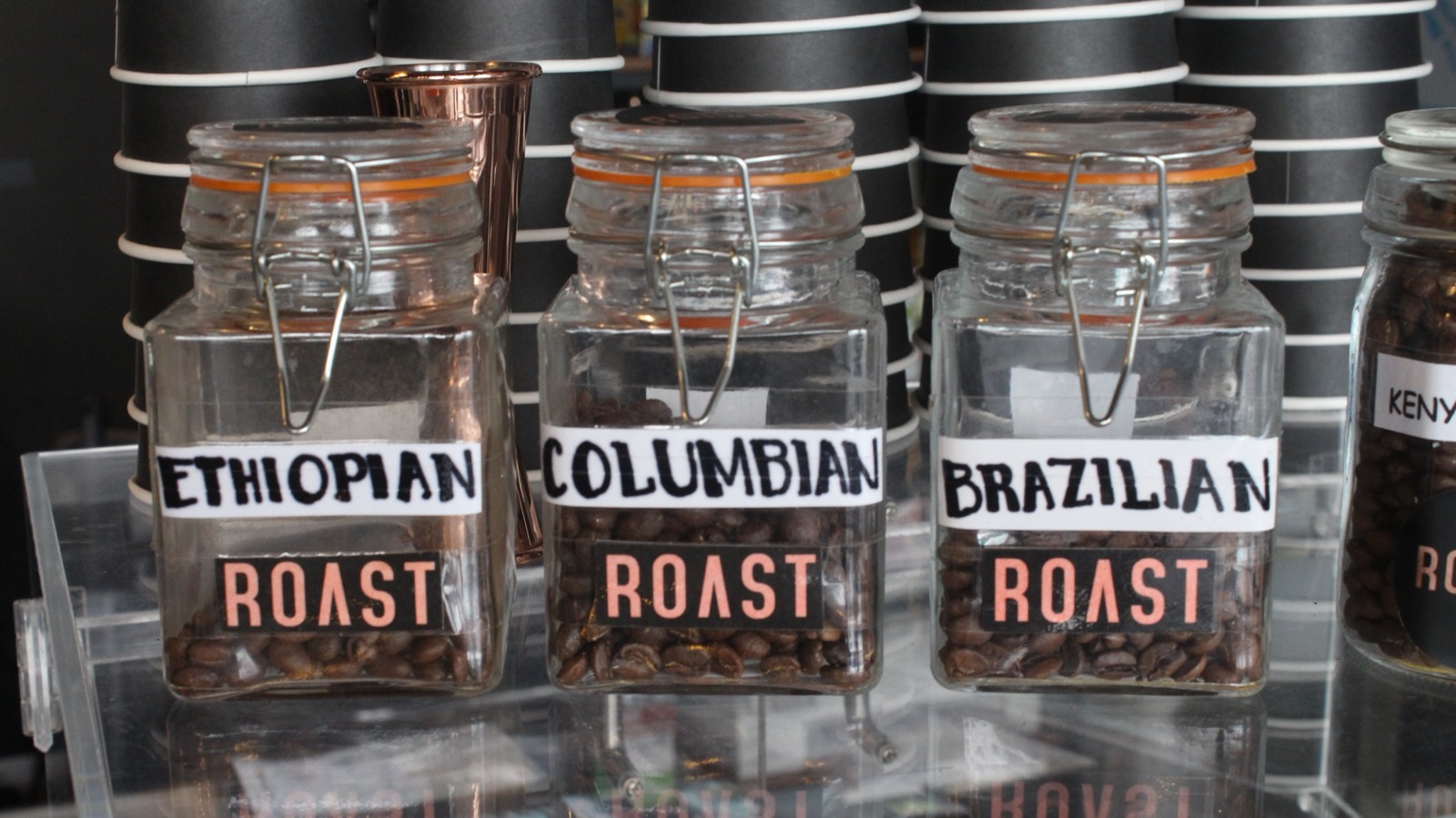 Single-origin beans — Ethiopian, Colombian, Brazilian — in ROAST jars